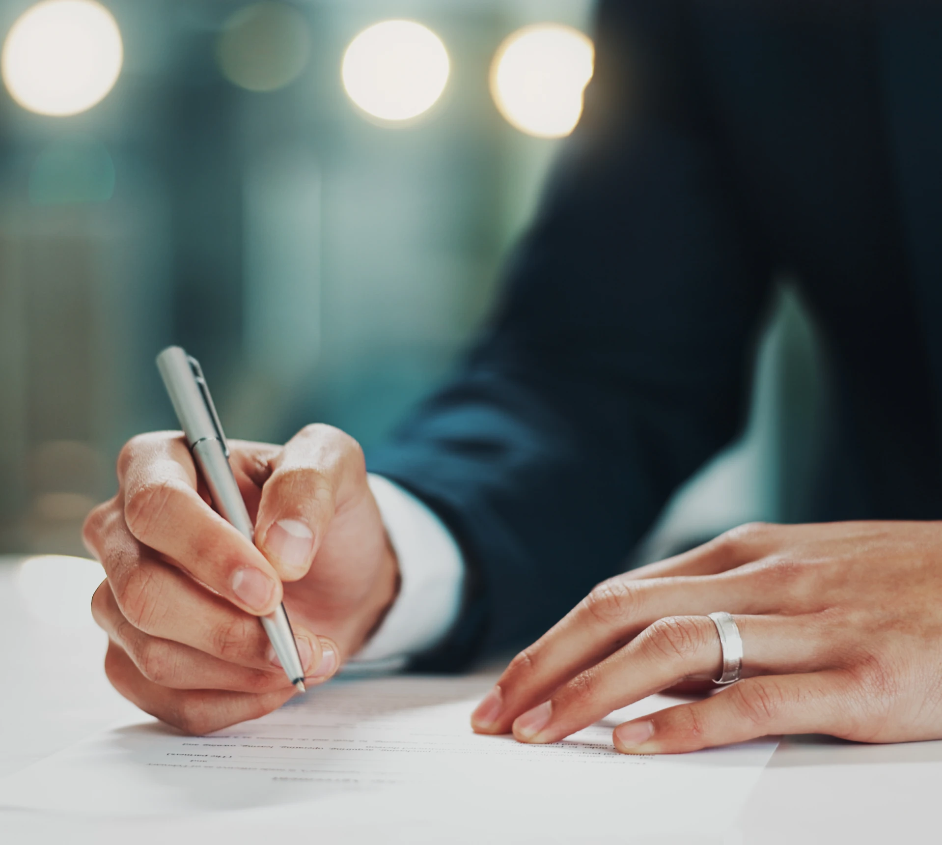 Businessperson writing on a document
