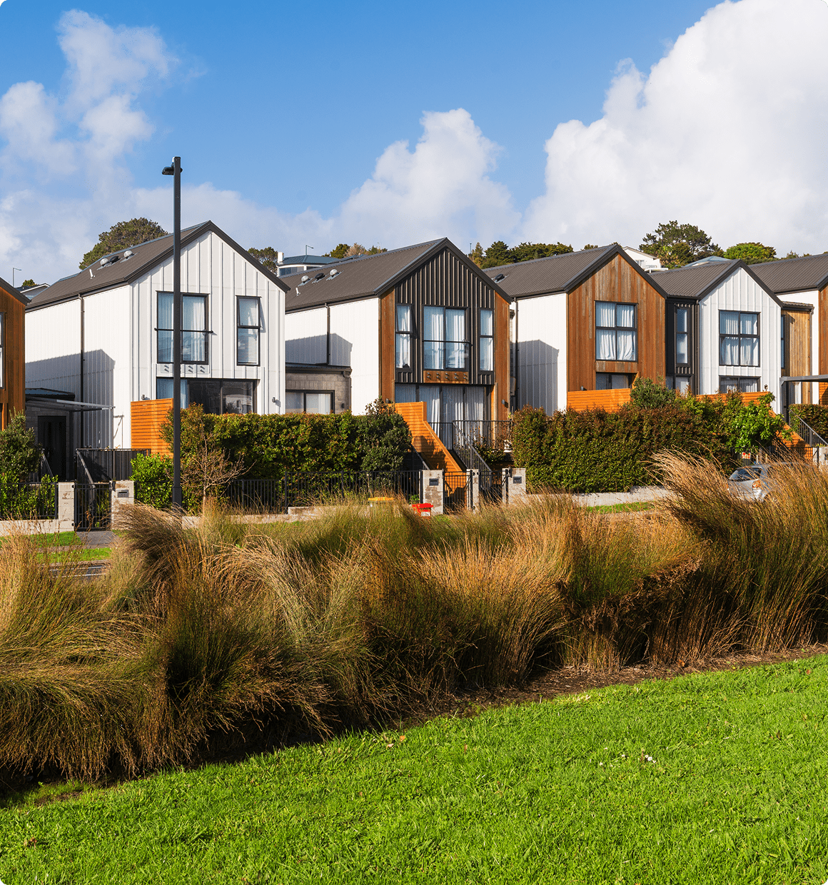 Modern townhouses with blue sky backdrop